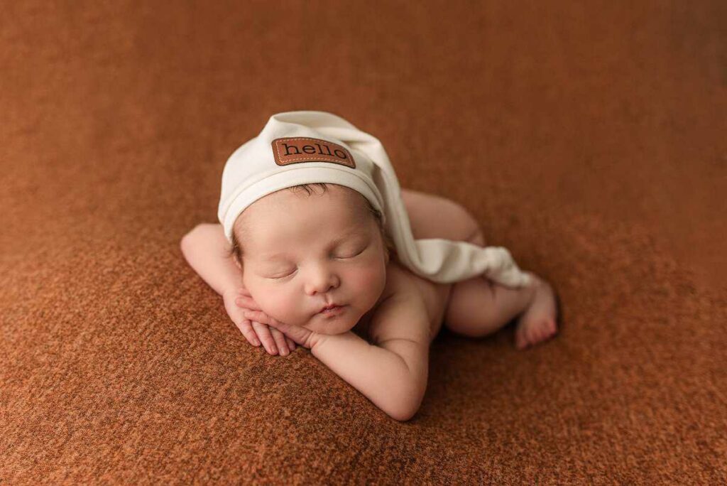 baby boy newborn, newborn boy photographed on orange, newborn hat, newborn boy gift, newborn photographer atlanta, atlanta newborn photography, baby photoshoot atlanta, newborn photos near me, professional newborn photographer