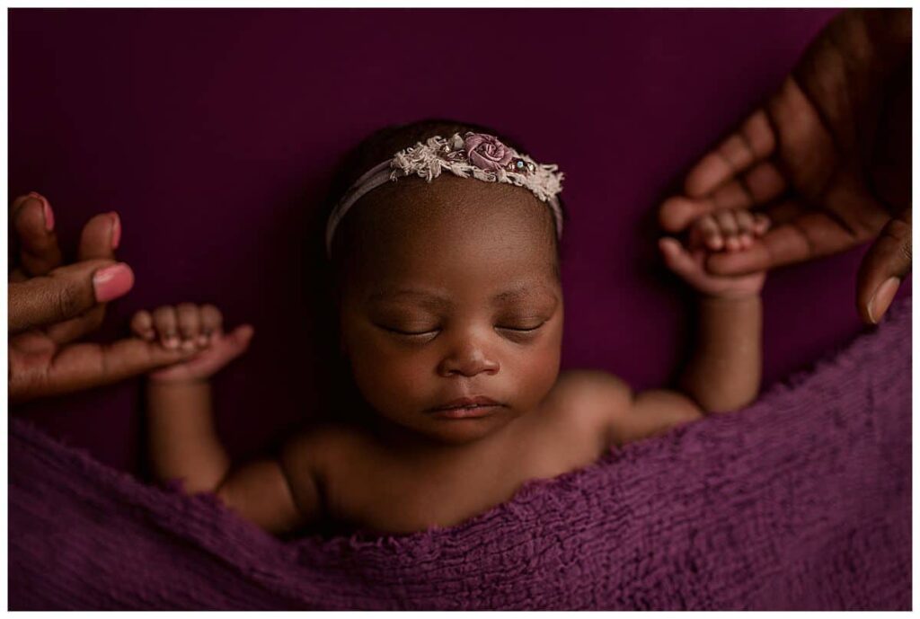 baby girl holding parents hands, purple newborn girl set up, simple newborn poses, poses with newborn and parents, newborn photography, newborn portrait session, baby photographer atlanta