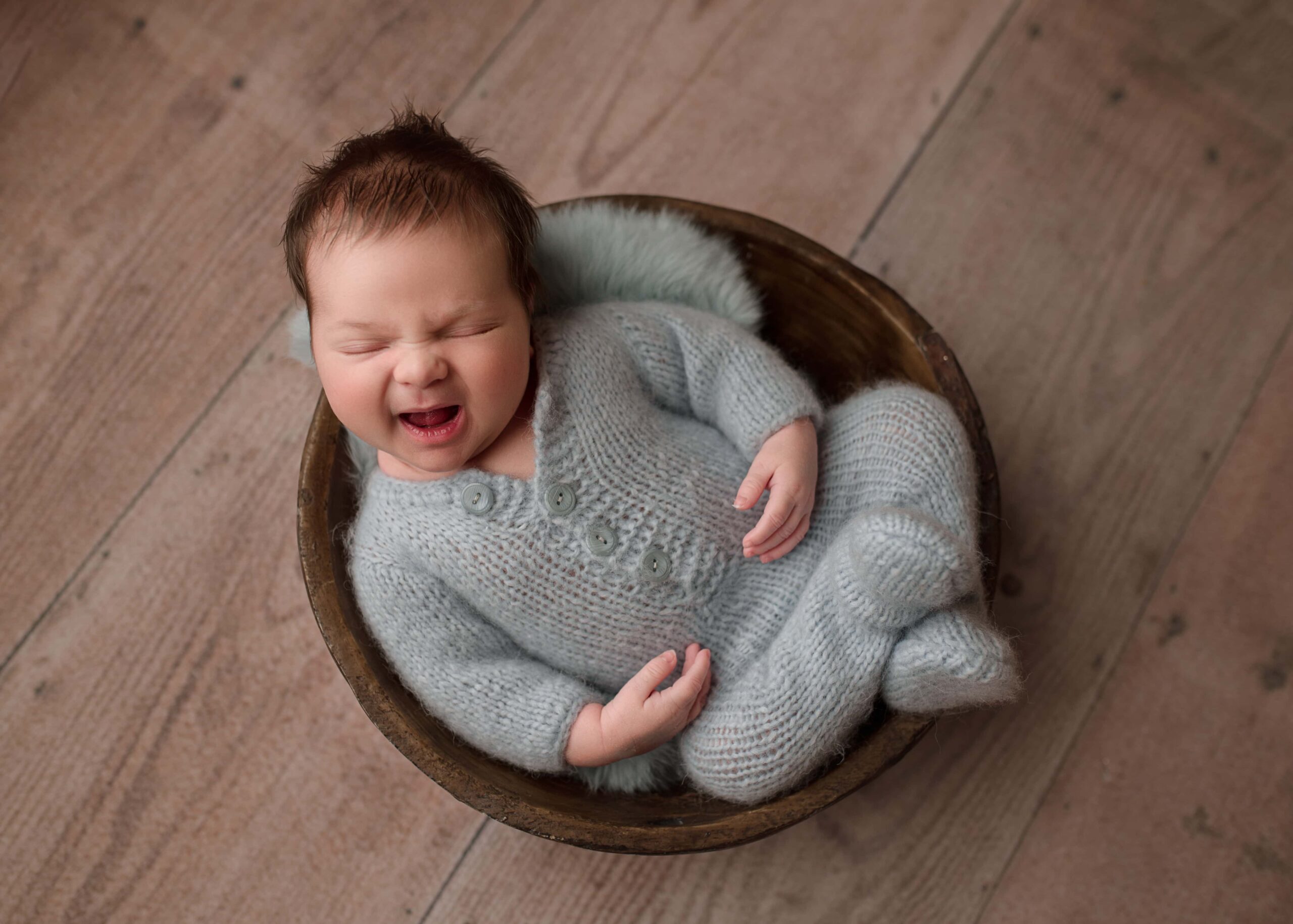 newborn photography lincoln ne, nebraska newborn photographer, lincoln nebraska baby photographer, baby boy wearing blue and smiling for his newborn photoshoot in lincoln nebraska