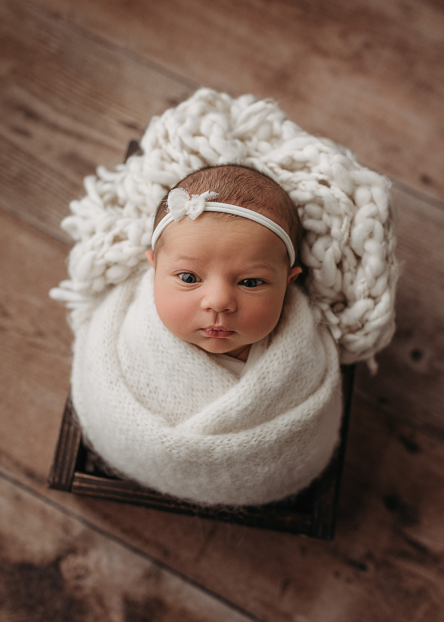 newborn girl wide awake during photoshoot, neutral newborn photographer, photographer with props nebraska