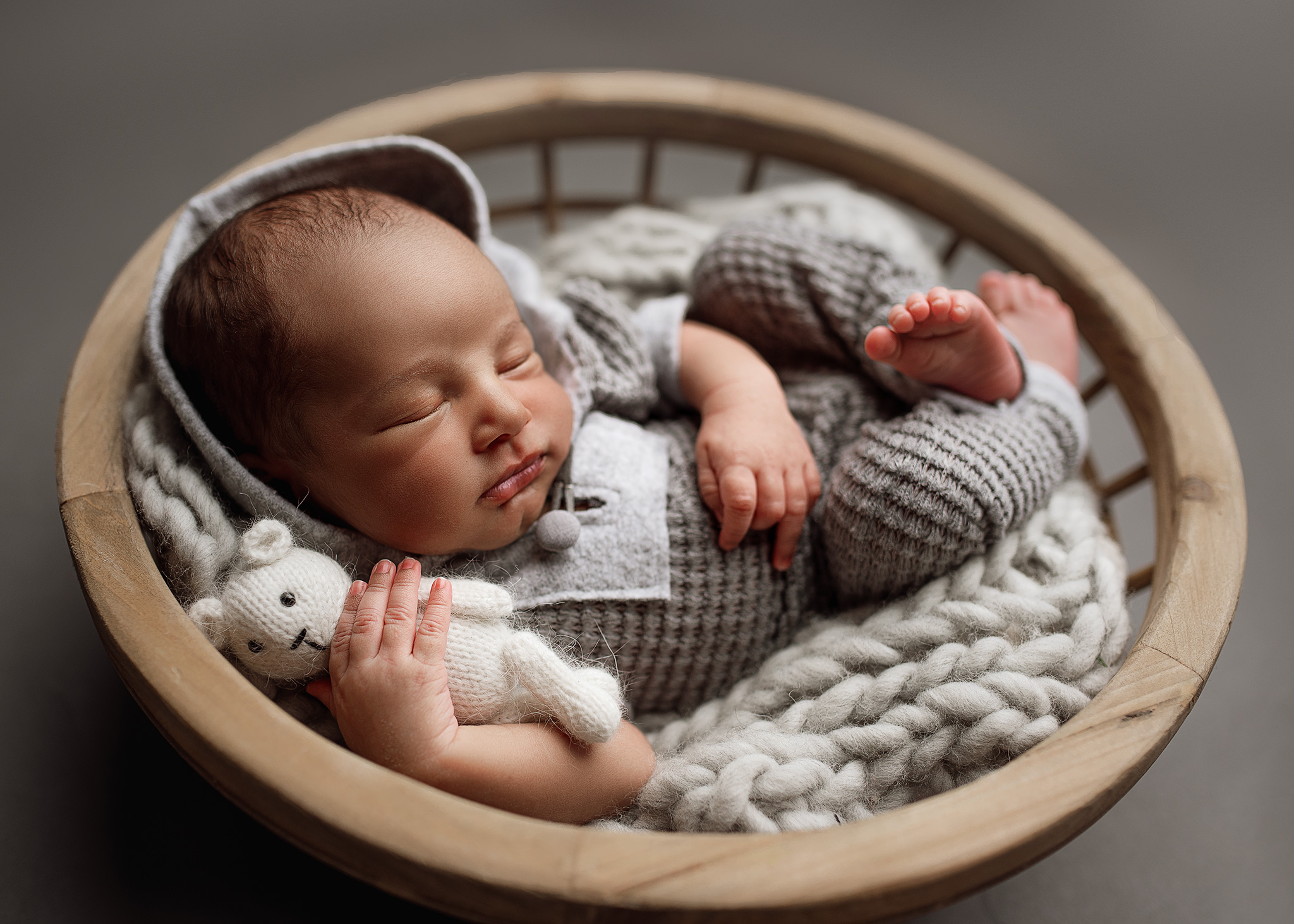 newborn posed in prop basket for newborn photoshoot, alpine lane newborn outfit, baby boy with little bear, nebraska baby photographer, newborn photography lincoln ne