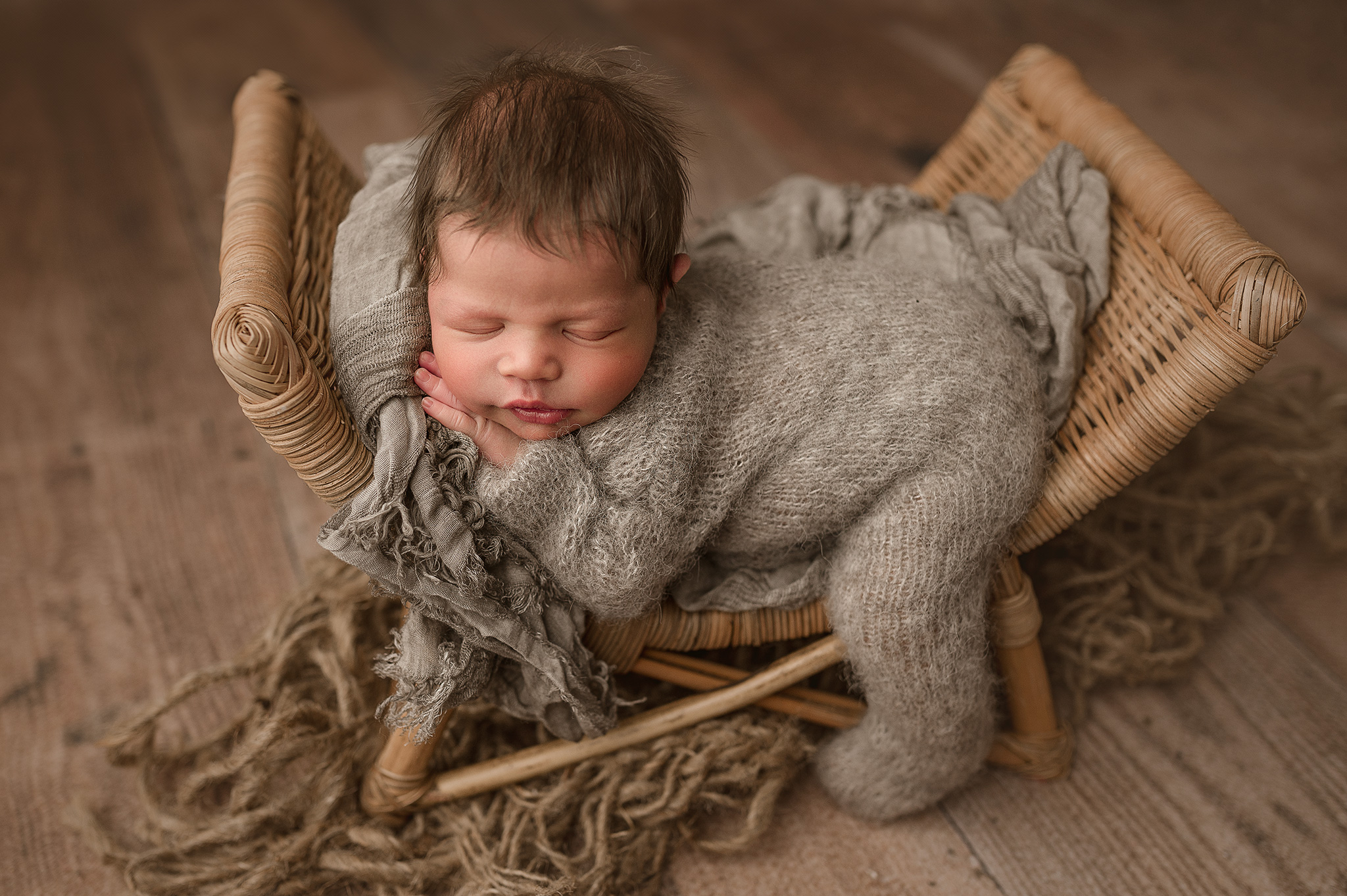 newborn photographer lincoln nebraska, studio photography nebraska, lincoln ne newborn photoshoot, newborn baby boy posed on prop in lincoln ne studio