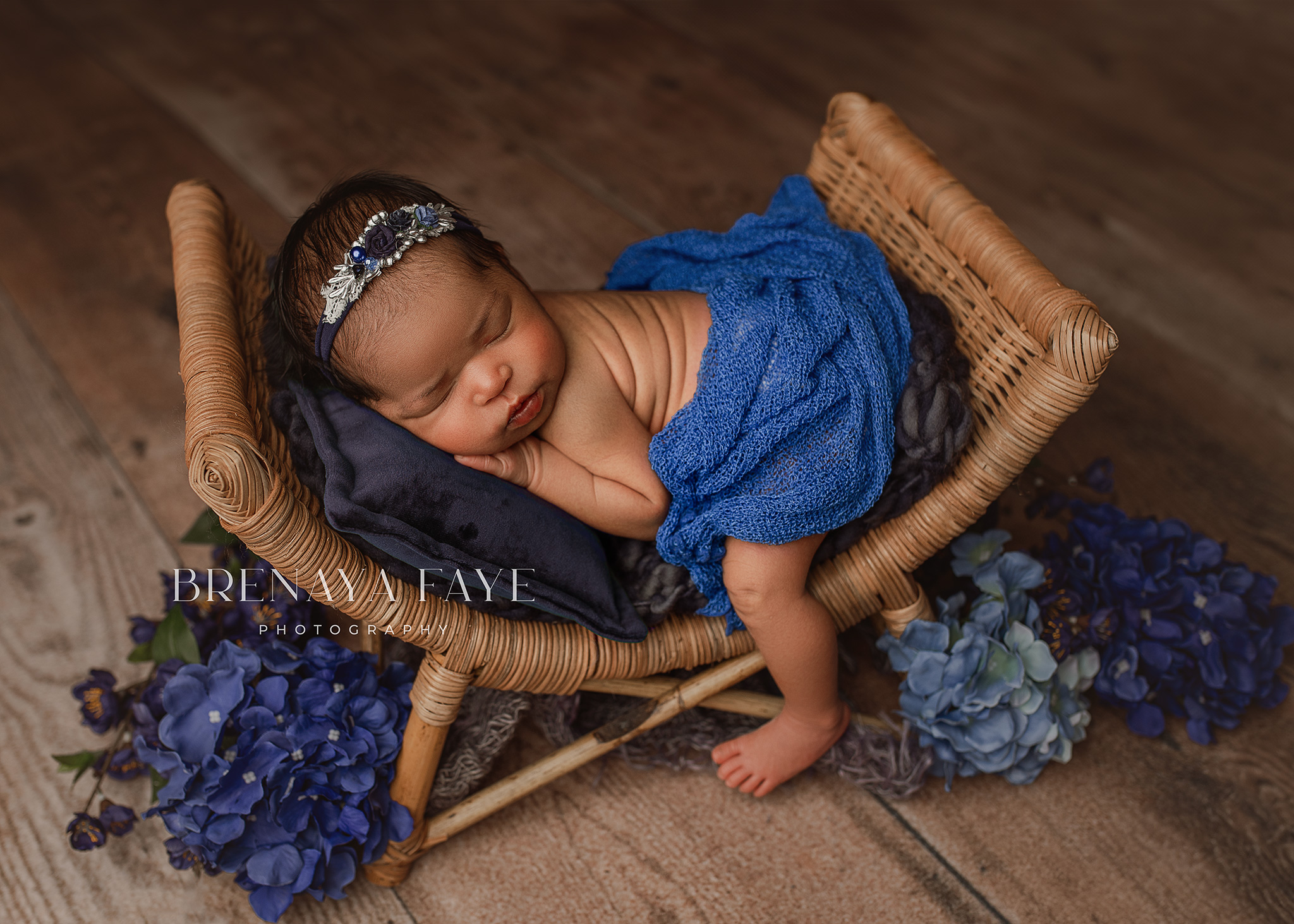 baby posed on prop for newborn photography session, baby girl in blue, newborn photo ideas using blue, omaha newborn photographer, photography studio lincoln nebraska