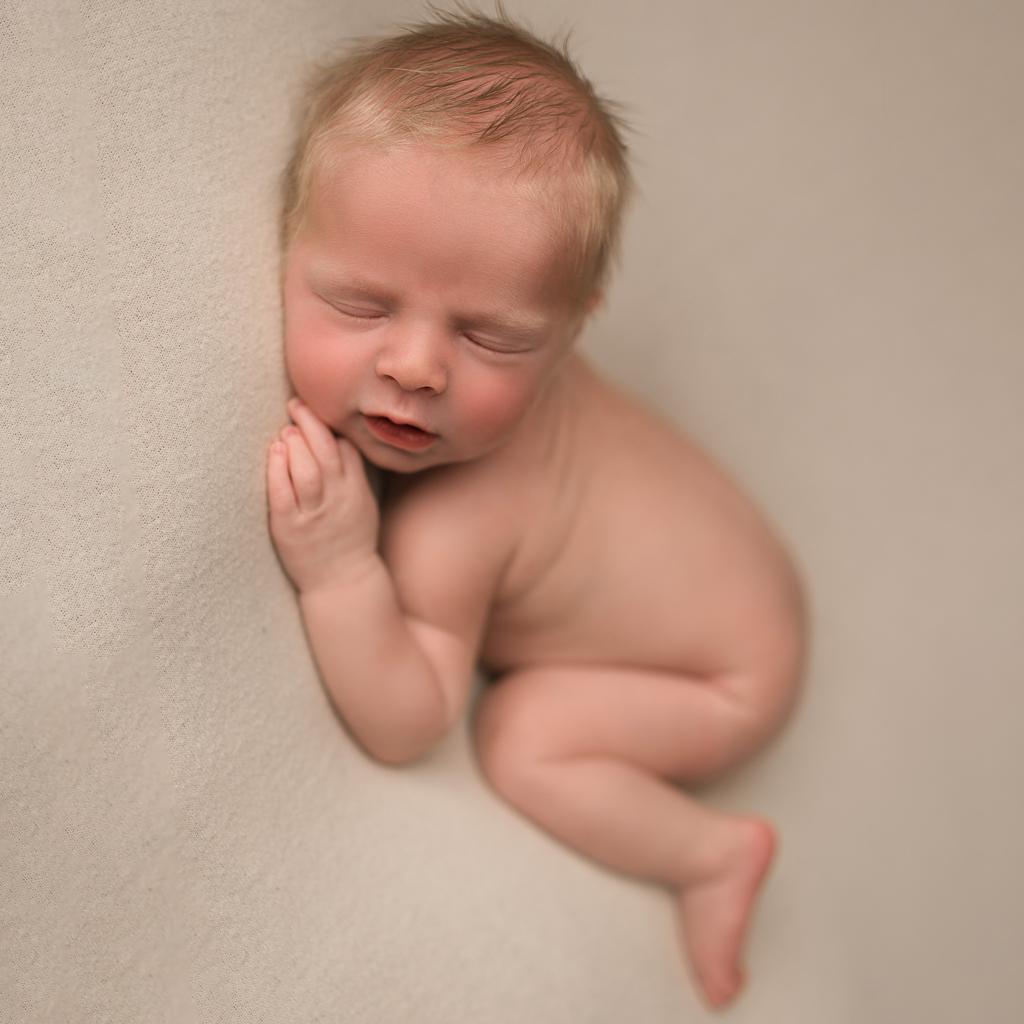 newborn baby posed in photography studio in nebraska for newborn session, newborn photoshoot ne, omaha newborn photography